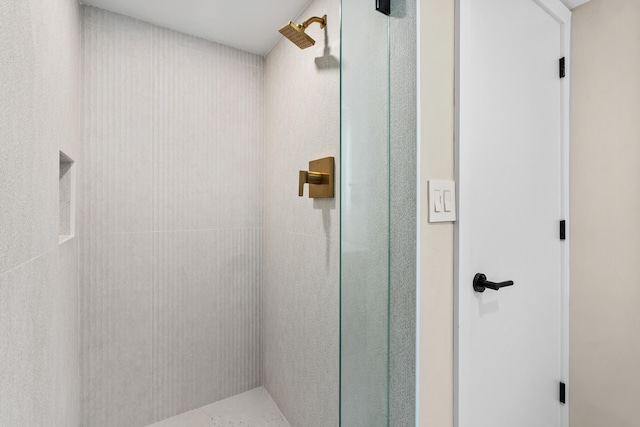 bathroom with tiled shower