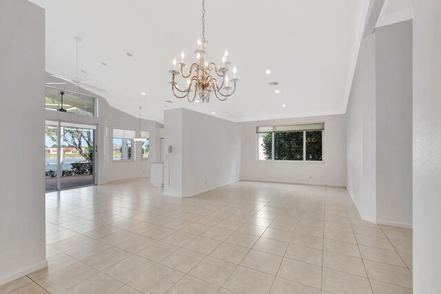 spare room with recessed lighting, ceiling fan with notable chandelier, baseboards, and light tile patterned flooring