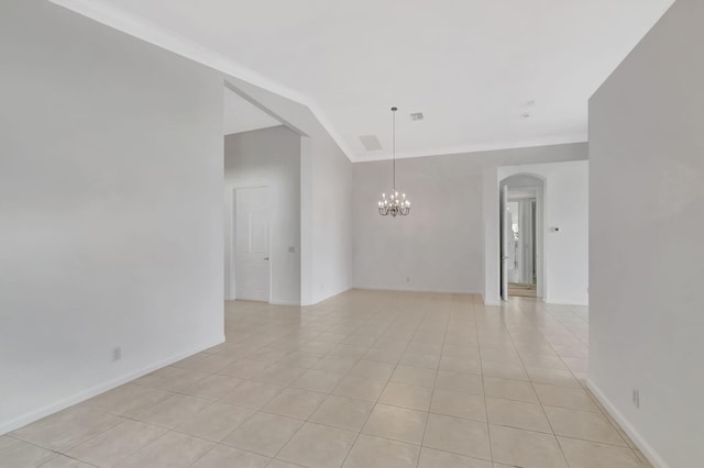 empty room with a notable chandelier, visible vents, light tile patterned flooring, vaulted ceiling, and baseboards