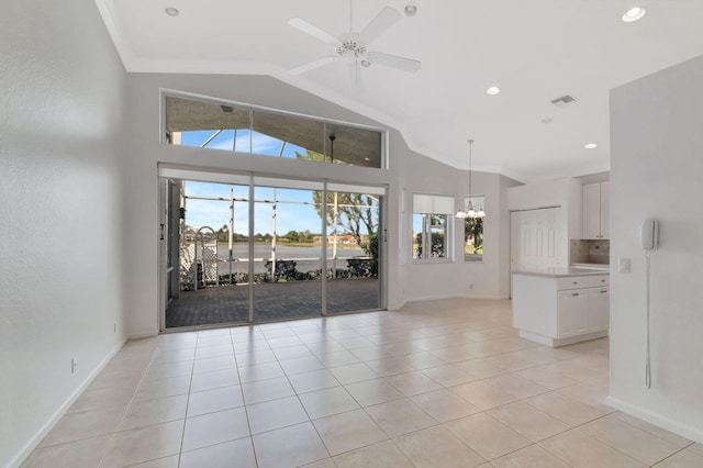 unfurnished living room with ceiling fan with notable chandelier, visible vents, baseboards, and light tile patterned floors