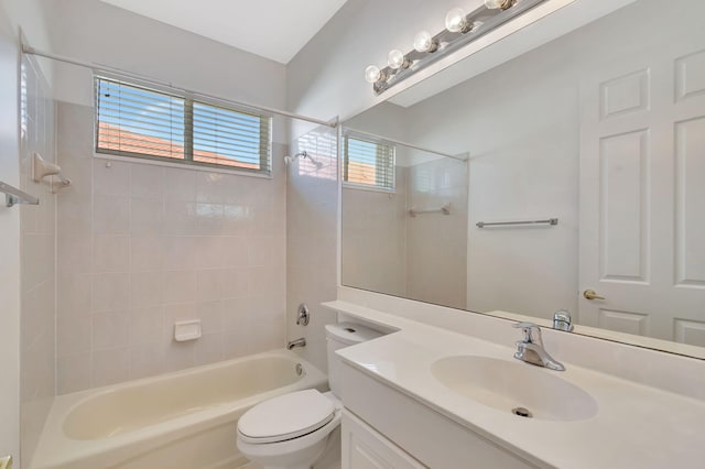 bathroom with washtub / shower combination, vanity, and toilet