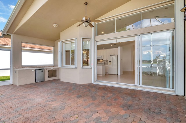 view of patio featuring ceiling fan and an outdoor kitchen