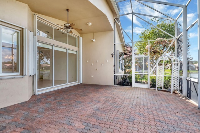 unfurnished sunroom with a ceiling fan