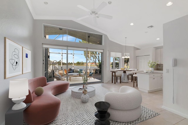 living room with a healthy amount of sunlight, light tile patterned floors, visible vents, and crown molding