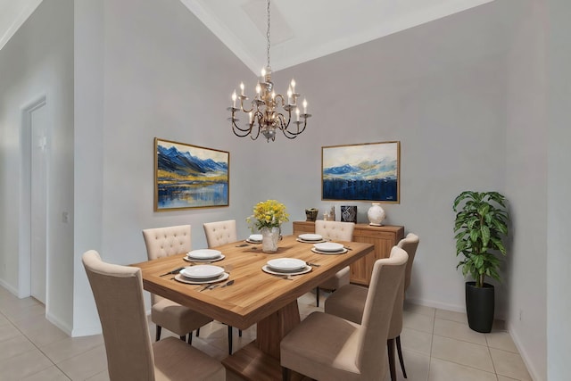 dining room with high vaulted ceiling, light tile patterned flooring, a notable chandelier, and baseboards