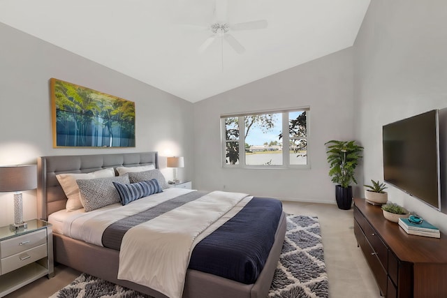 bedroom featuring vaulted ceiling, baseboards, a ceiling fan, and light colored carpet