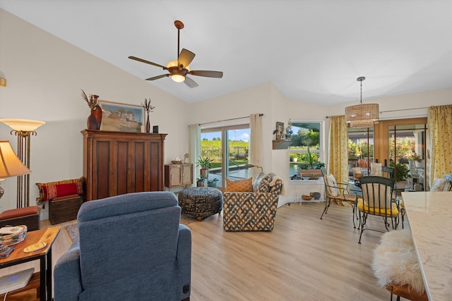 living room featuring vaulted ceiling, ceiling fan, and light hardwood / wood-style floors