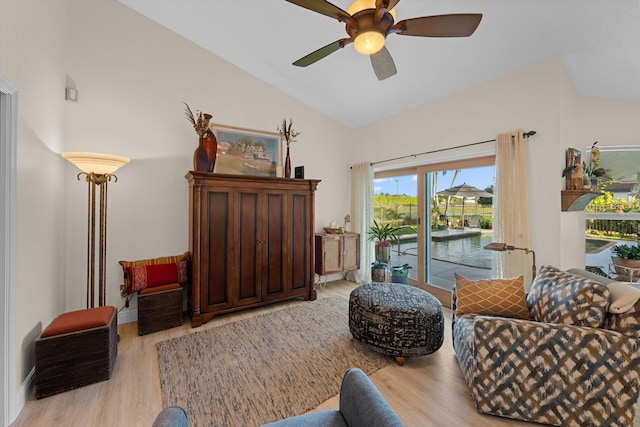 living area with lofted ceiling, light hardwood / wood-style floors, and ceiling fan