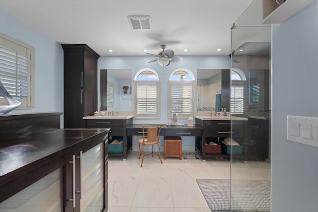 interior space with ceiling fan, sink, and dark brown cabinets