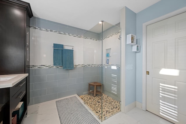 bathroom featuring vanity and an enclosed shower