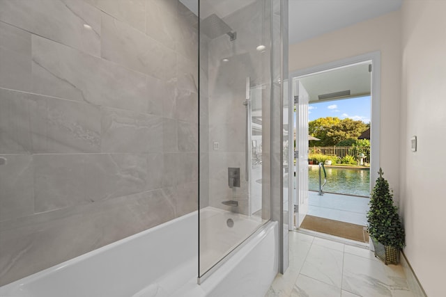 bathroom with tiled shower / bath and a water view