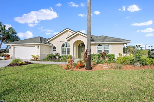 ranch-style house featuring a garage and a front yard