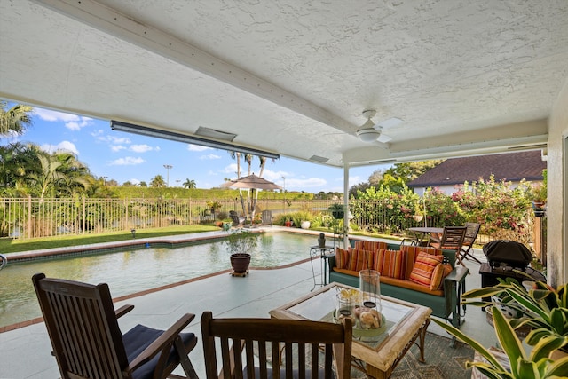 view of patio / terrace with a fenced in pool, an outdoor hangout area, and ceiling fan