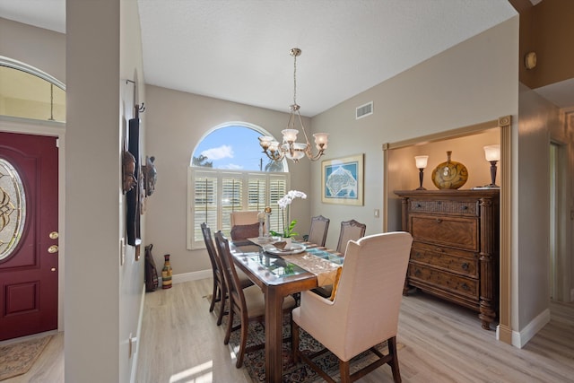 dining room with a chandelier and light hardwood / wood-style flooring