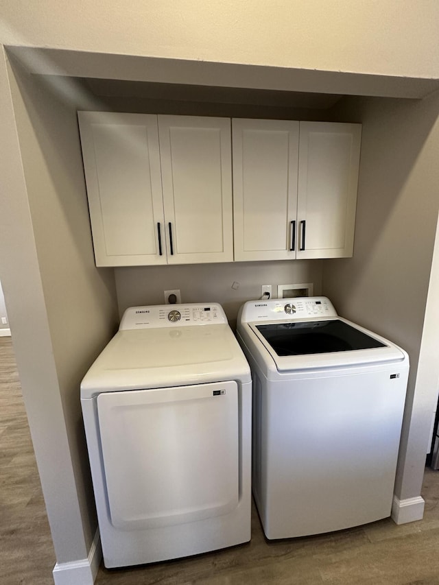 laundry area featuring separate washer and dryer and hardwood / wood-style floors