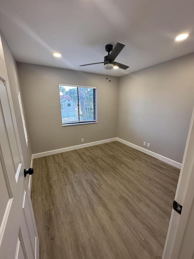 empty room featuring dark hardwood / wood-style floors and ceiling fan