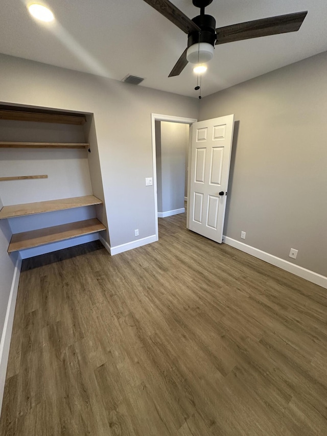 unfurnished bedroom with dark hardwood / wood-style floors and ceiling fan