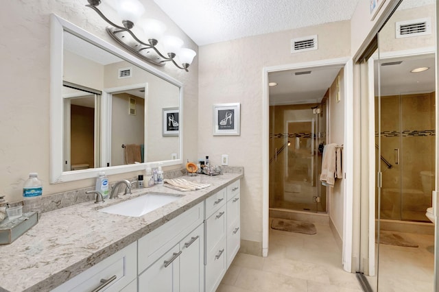 full bathroom with a stall shower, visible vents, and vanity