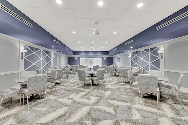 carpeted dining area with an accent wall, visible vents, and recessed lighting