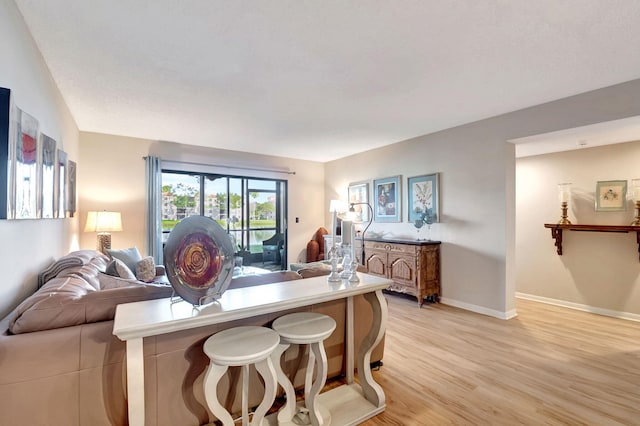 living room featuring light wood-style flooring and baseboards