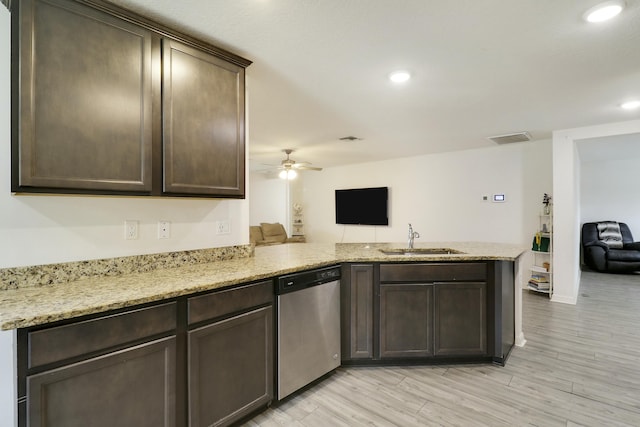 kitchen featuring a peninsula, a sink, visible vents, dark brown cabinets, and stainless steel dishwasher