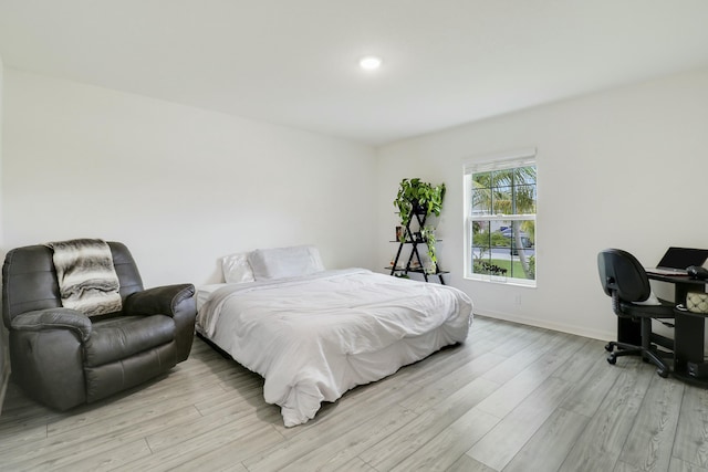 bedroom with light wood-style floors, baseboards, and recessed lighting