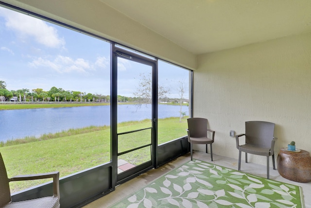 sunroom / solarium featuring a water view