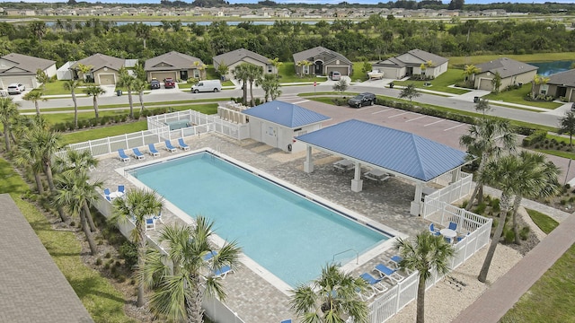 pool featuring a patio area, a residential view, and fence