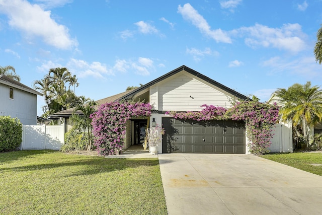 view of front of home featuring a garage and a front lawn