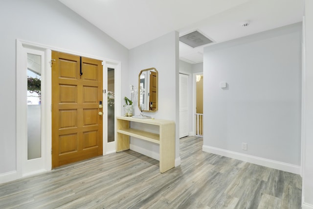 entrance foyer featuring vaulted ceiling and light wood-type flooring