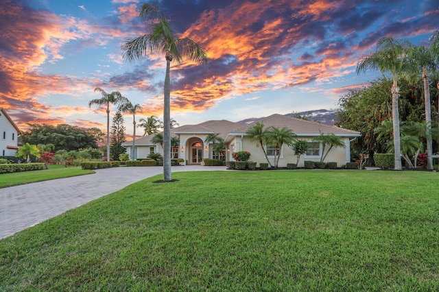 mediterranean / spanish-style house featuring a lawn