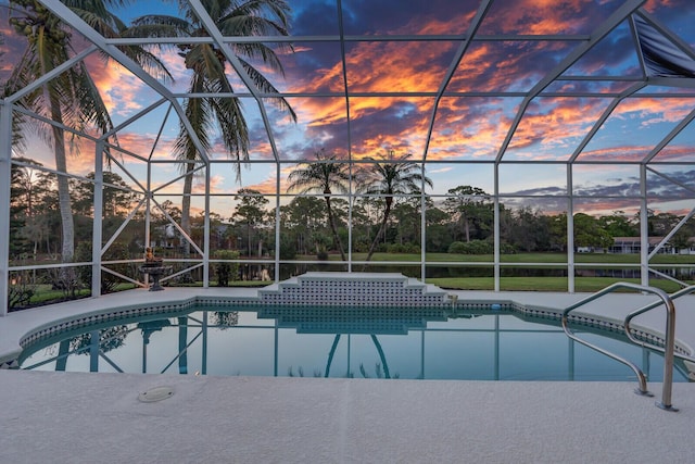 pool at dusk with a lanai