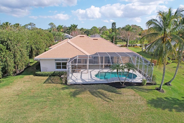 back of house with a yard, a lanai, and a patio area