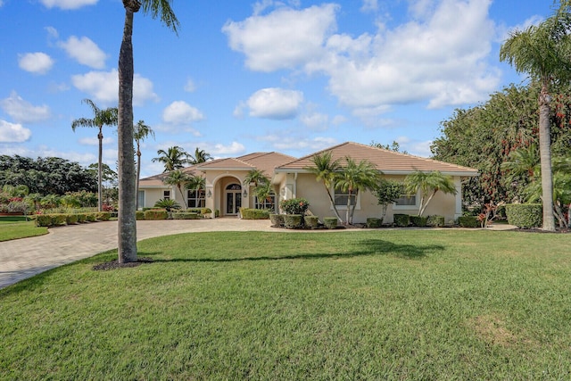 mediterranean / spanish home featuring a front yard