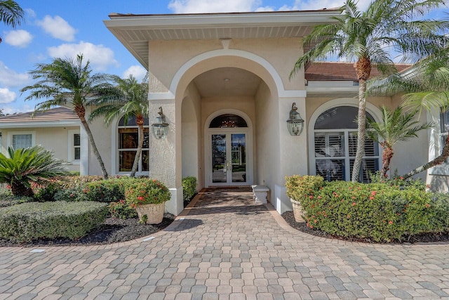 view of exterior entry featuring french doors