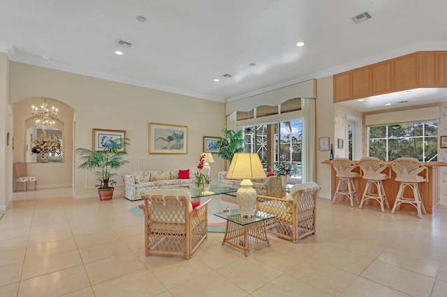 living room featuring crown molding, light tile patterned floors, and a notable chandelier