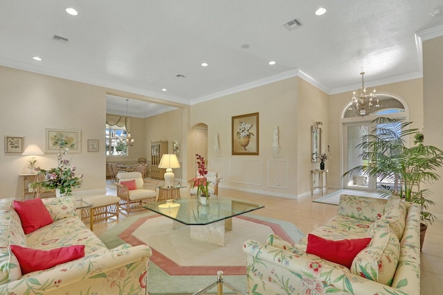 living room with ornamental molding, a chandelier, and light tile patterned flooring