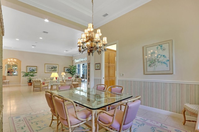 dining room featuring crown molding, light tile patterned floors, and a chandelier