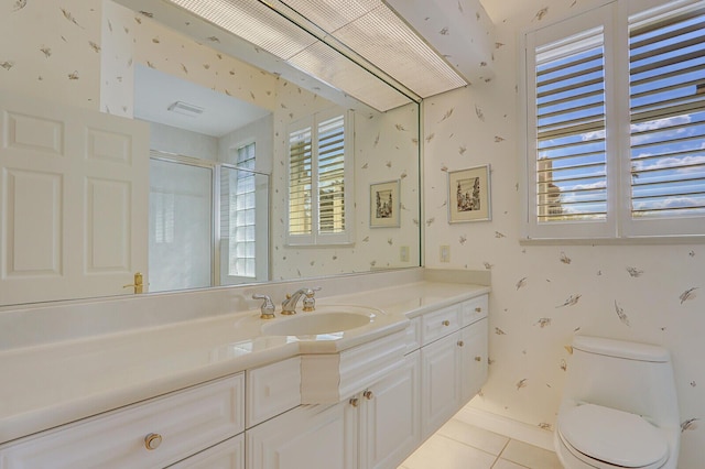 bathroom with walk in shower, tile patterned floors, toilet, and vanity