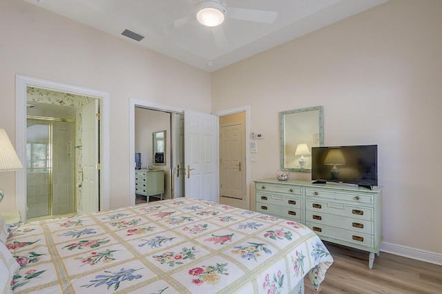 bedroom featuring ensuite bath, ceiling fan, and light hardwood / wood-style flooring