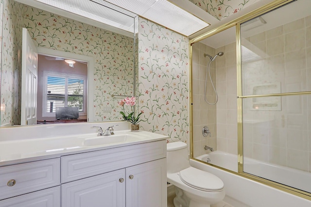 full bathroom with vanity, combined bath / shower with glass door, and toilet