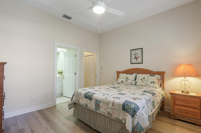 bedroom featuring ceiling fan, a closet, connected bathroom, and light hardwood / wood-style flooring