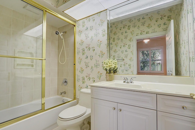 full bathroom with bath / shower combo with glass door, vanity, and toilet