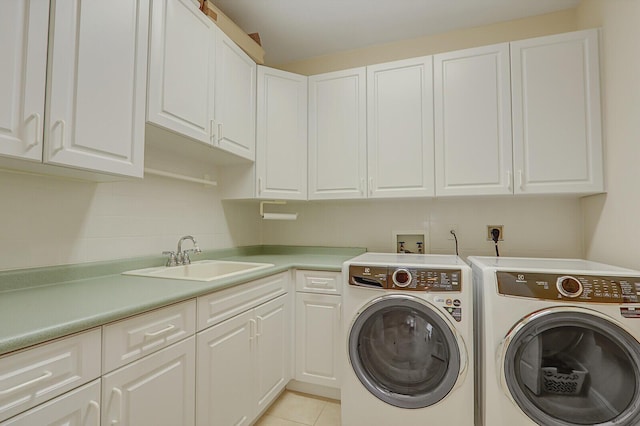 clothes washing area featuring cabinets, light tile patterned flooring, sink, and independent washer and dryer