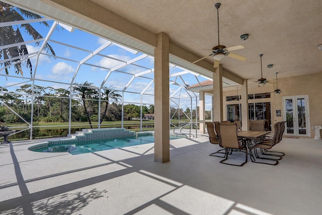 view of swimming pool featuring french doors, ceiling fan, a lanai, and a patio area