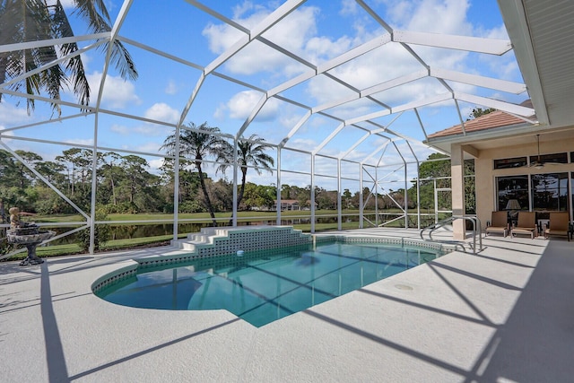 view of pool with a patio and glass enclosure