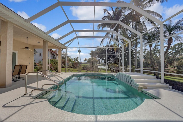 view of swimming pool featuring ceiling fan, a patio, and glass enclosure