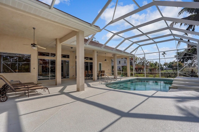 view of swimming pool with a patio, a lanai, and ceiling fan