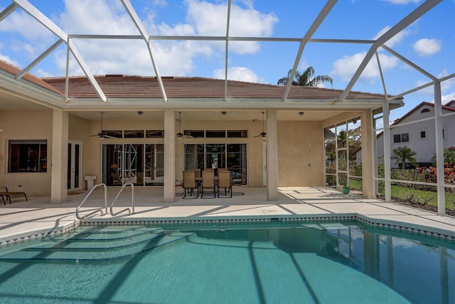 view of swimming pool featuring a lanai, a patio area, and ceiling fan