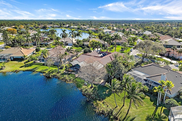 drone / aerial view featuring a water view and a residential view